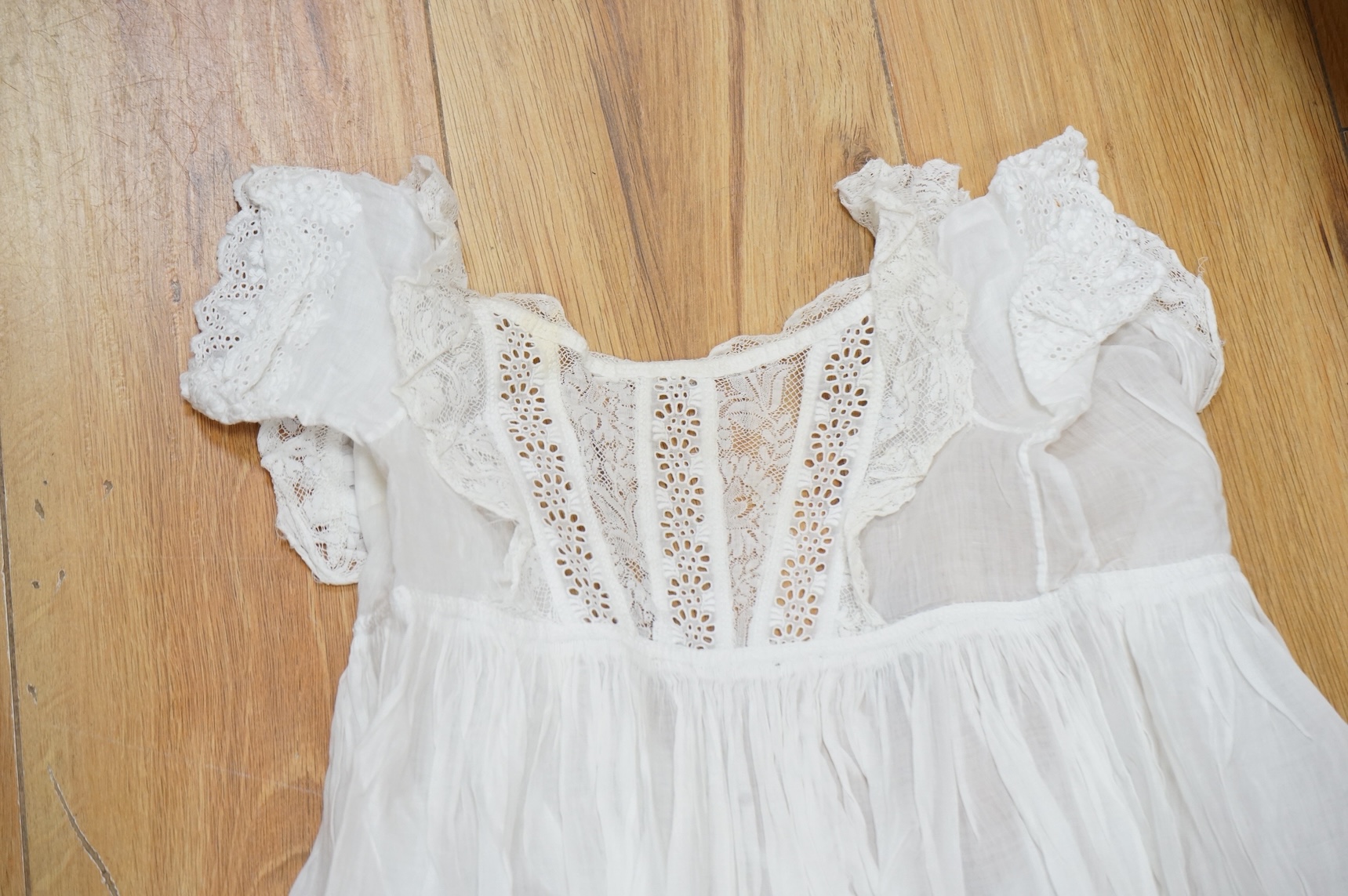 A collection Victorian textiles to include a lace christening gown, Irish crochet and a net baby gown